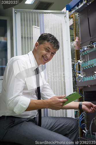 Image of network engineer working in  server room