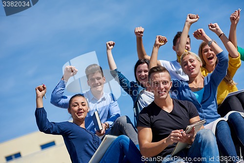 Image of students outside sitting on steps