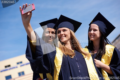 Image of students group in graduates making selfie