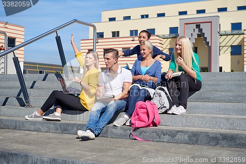 Image of students outside sitting on steps