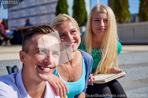 Image of students outside sitting on steps