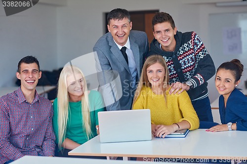 Image of group of students getting suppport from teacher