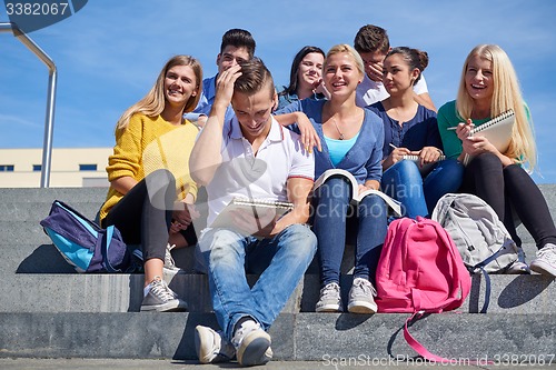 Image of students outside sitting on steps