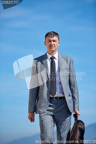 Image of senior  businessman outdoors