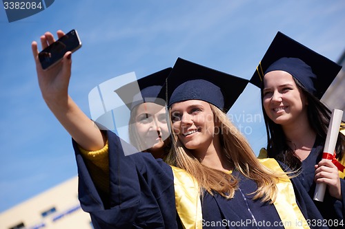 Image of students group in graduates making selfie