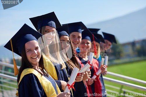 Image of young graduates students group