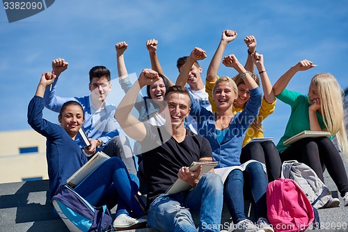 Image of students outside sitting on steps