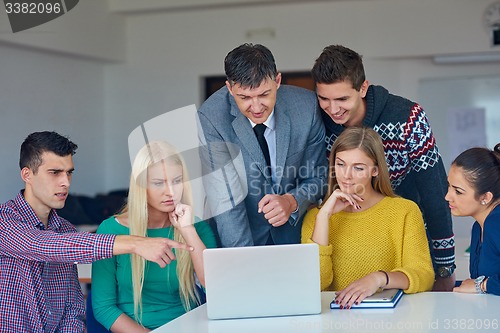 Image of group of students getting suppport from teacher