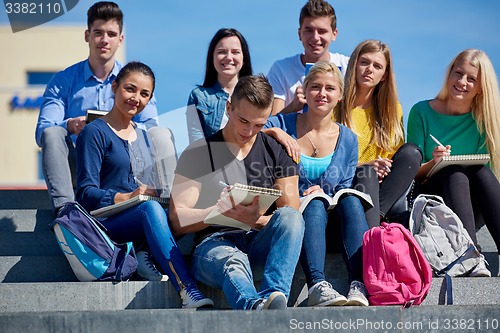 Image of students outside sitting on steps