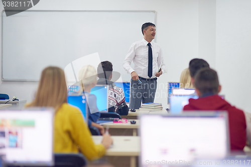 Image of students with teacher  in computer lab classrom