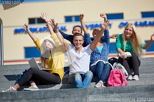 Image of students outside sitting on steps