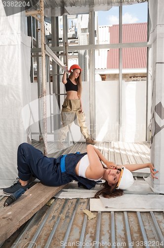 Image of Attractive women relax on construction site