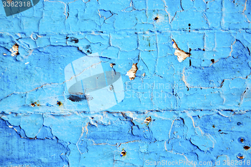 Image of dirty  paint in  blue   door  rusty nail