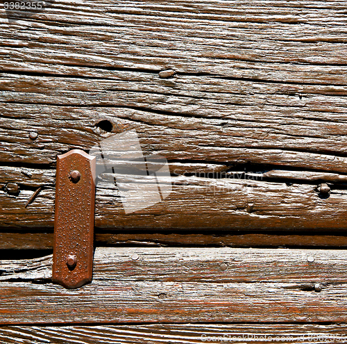 Image of door    in italy old ancian wood and traditional  texture nail