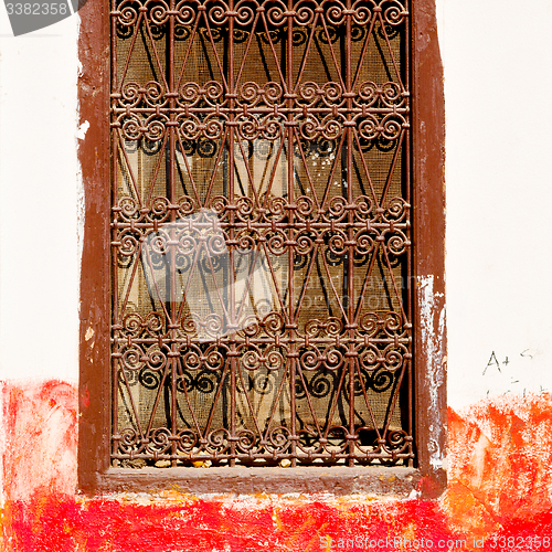 Image of red   window in morocco africa old construction and brown wall  