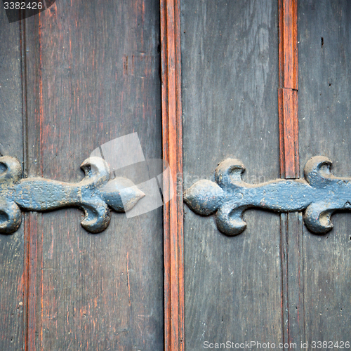 Image of handle in london antique brown door  rusty  brass nail and light