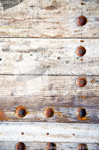 Image of metal nail dirty stripped paint in the 