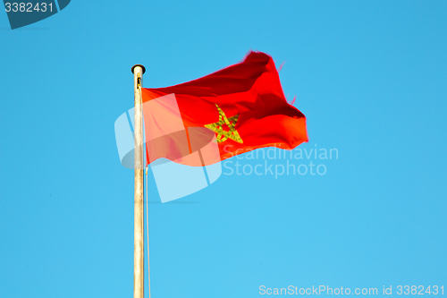 Image of tunisia  waving flag in the blue sky  colour and battlements  