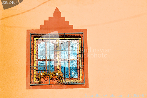 Image of blue window in old  and brown wall  construction