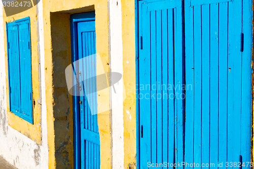 Image of old door in morocco africa  wall ornate blue yellow