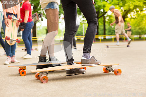 Image of Teenage girl practicing riding long board.