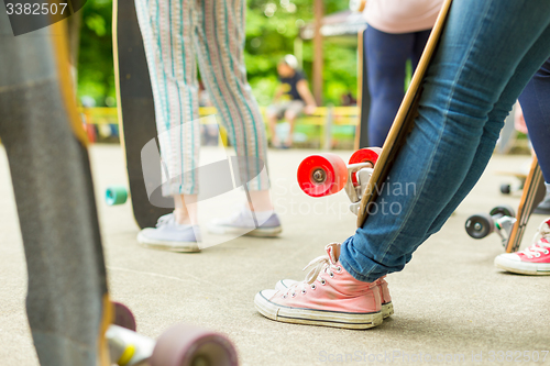 Image of Teenage girl practicing riding long board.