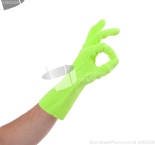 Image of Hand gesturing with green cleaning product glove