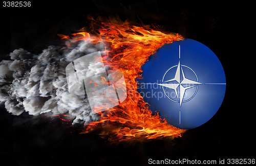 Image of Flag with a trail of fire and smoke - NATO