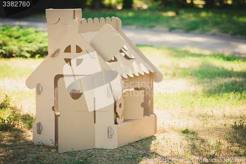 Image of Toy house made of corrugated cardboard in the city park 