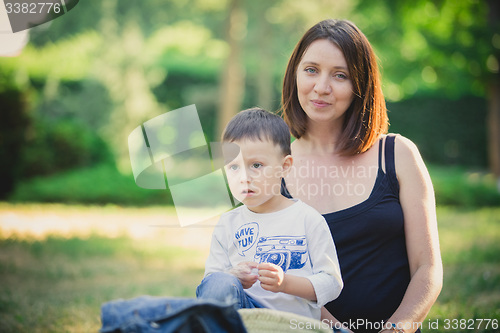 Image of Mother and son in the park summer day.