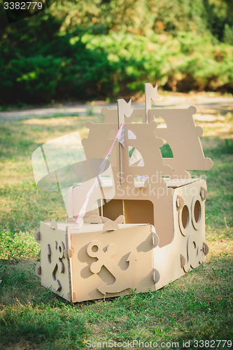 Image of Cardboard toy boat in the park.