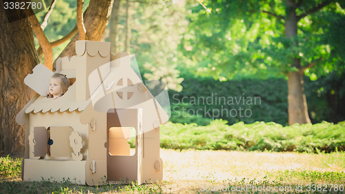 Image of Toy house made of corrugated cardboard in the city park 