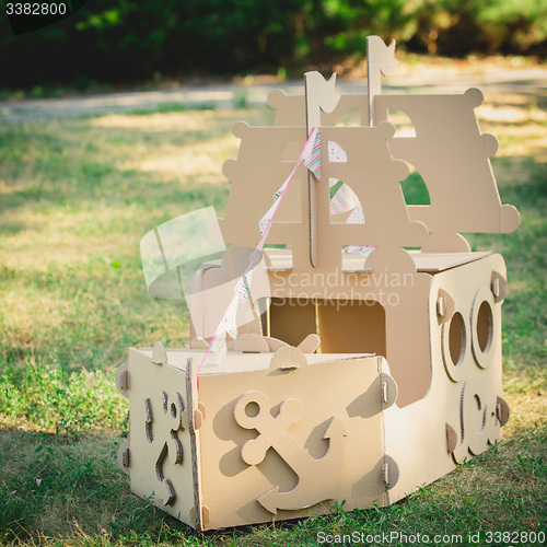 Image of Cardboard toy boat in the park.