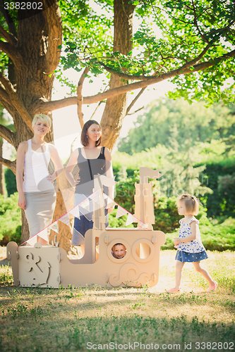 Image of female family playing with the children