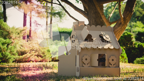 Image of Toy house made of corrugated cardboard in the city park 