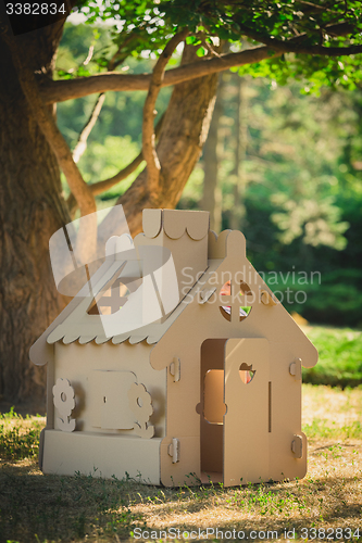 Image of Toy house made of corrugated cardboard in the city park