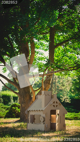 Image of Toy house made of corrugated cardboard in the city park 