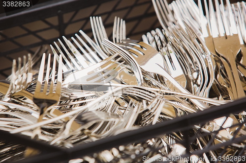 Image of Closeup of shiny spoon, knife, fork