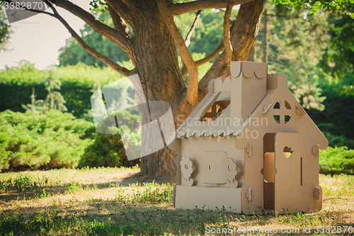 Image of Toy house made of corrugated cardboard in the city park 