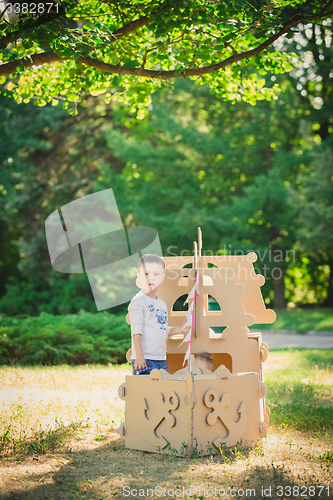 Image of Boy and girl playing in a cardboard boat