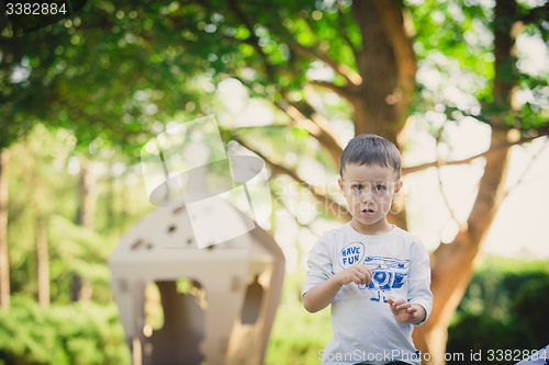 Image of child playing in a cardboard spaceship. Eco concept