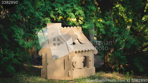 Image of Toy house made of corrugated cardboard in the city park 