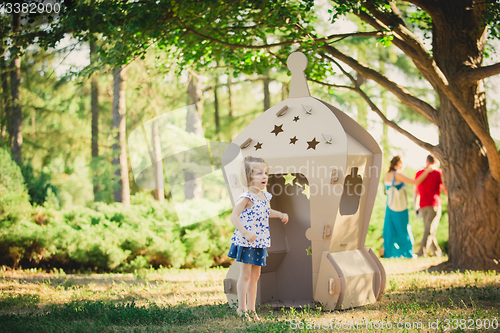 Image of girl playing in cardboard spaceship 