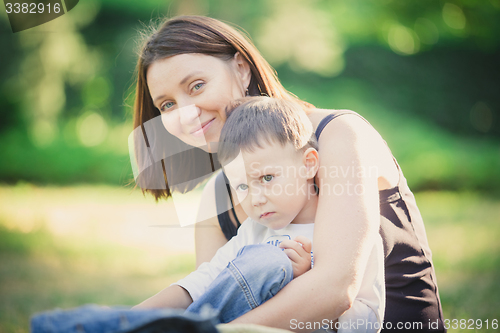 Image of Mother and son in the park summer day.