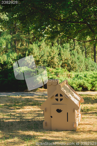 Image of Toy house made of corrugated cardboard in the city park 