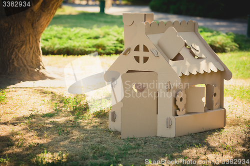 Image of Toy house made of corrugated cardboard in the city park 