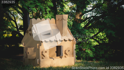 Image of Toy house made of corrugated cardboard in the city park 