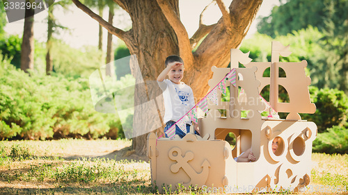 Image of Boy and girl playing in a cardboard boat