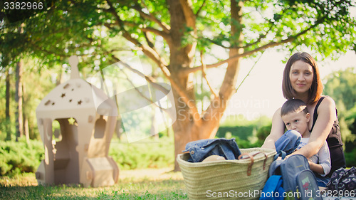 Image of Mother and son in the park summer day.