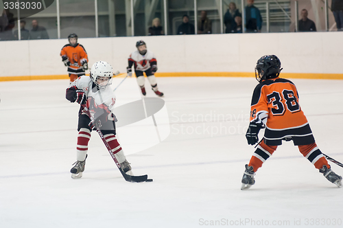 Image of Game between children ice-hockey teams